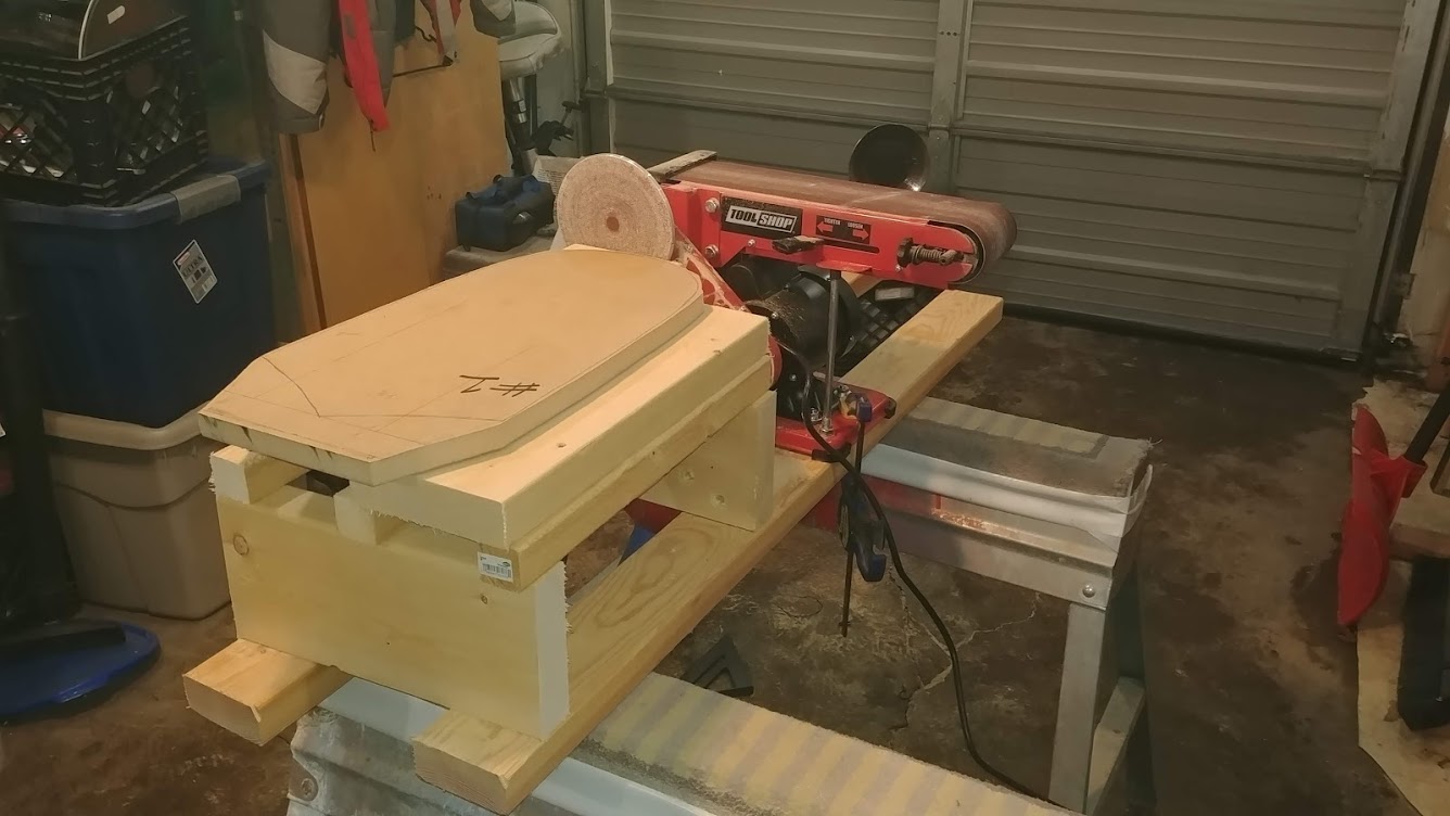 Picture of a mold station sitting next to the table-top belt sander.
